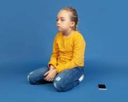 portrait-sad-little-girl-sitting-isolated-blue-background_155003-32393-300×200-1